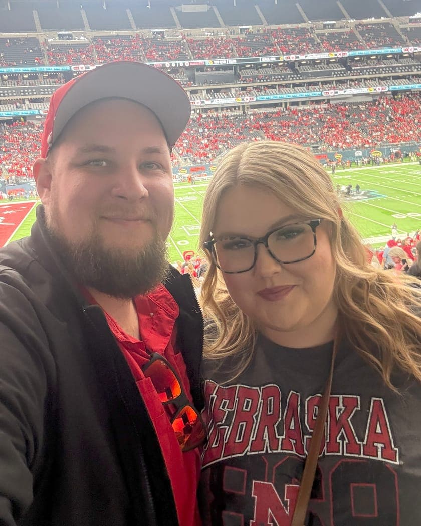 Brent Clouse and his wife Hannah in the stands at a Nebraska Cornhuskers football game